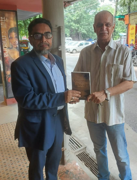 Dr. Ashok Kumar Singha presenting a book